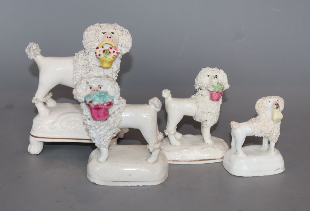 Four Staffordshire porcelain figures of a poodle grasping a basket in its mouth, c.1840 -50, H. 6.4 - 12cm